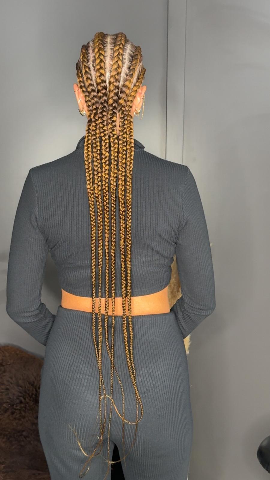 Golden feed-in braids styled by Zaina